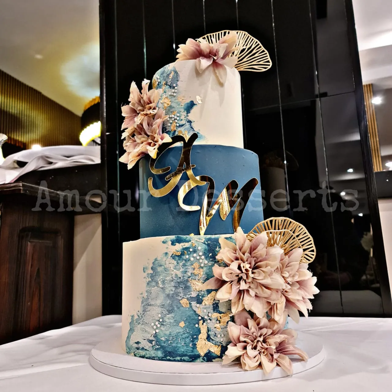 Navy and gold custom cake with sugar flowers
