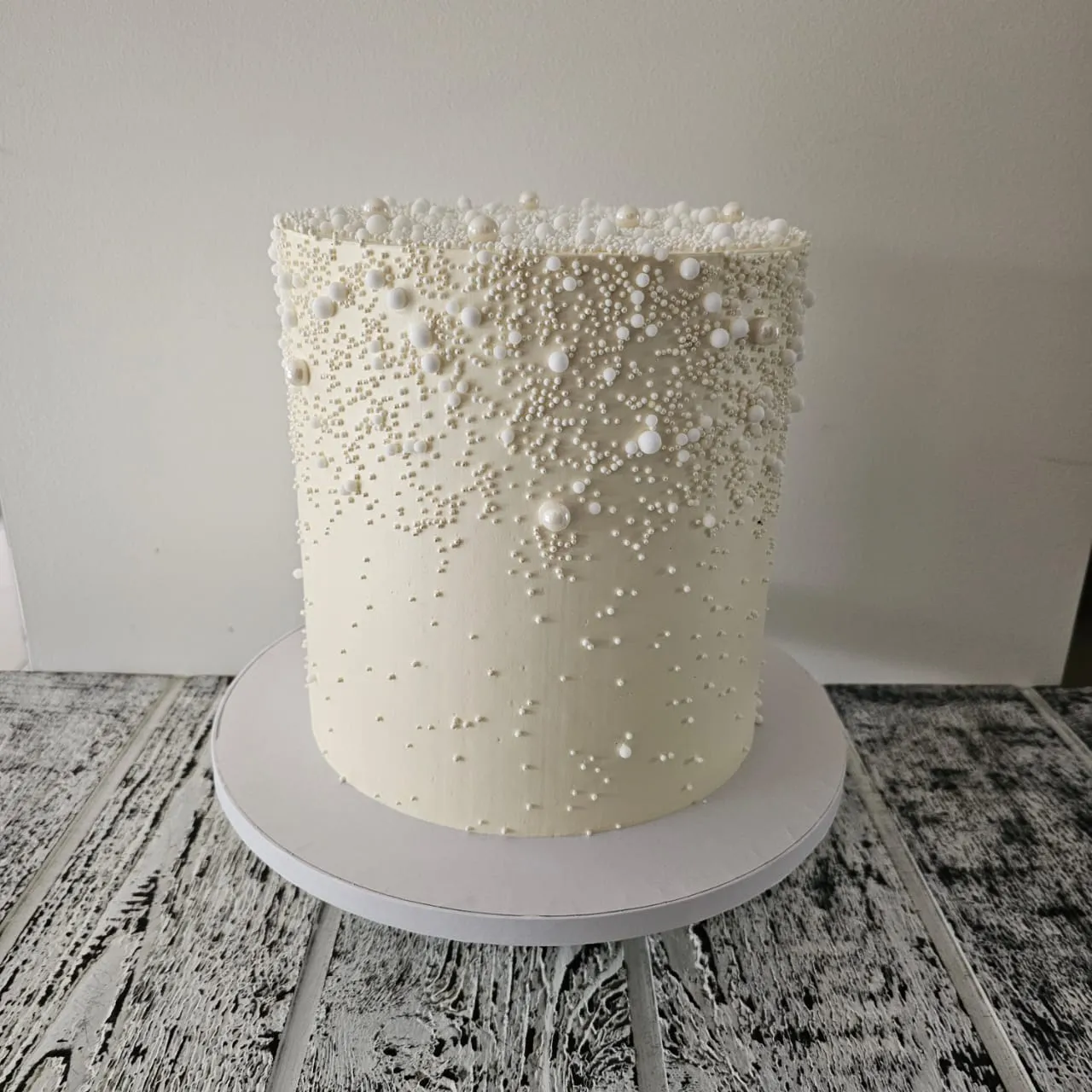 White custom cake with cascading pearl detail