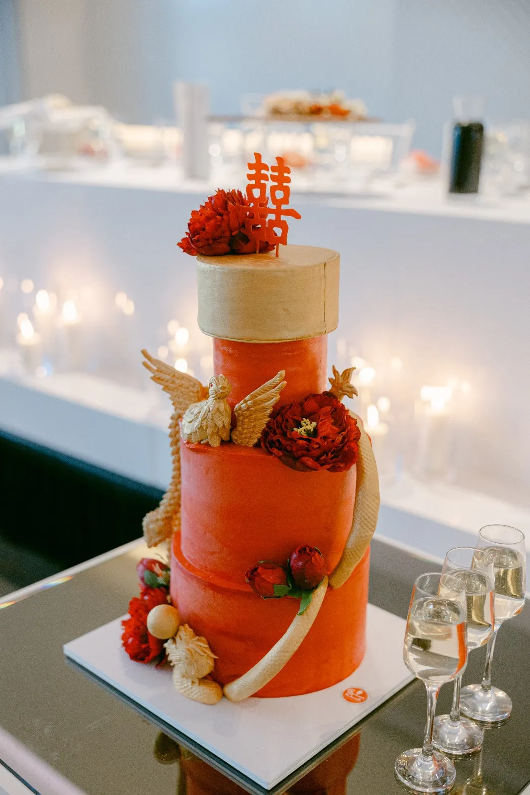 Red and gold custom cake with phoenix detail