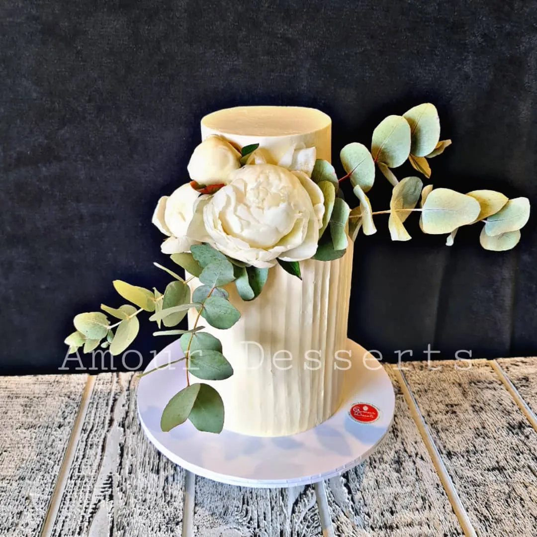 White textured custom cake with a sugar peony