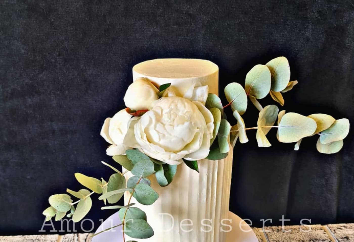 Ribbed white custom cake with a handmade sugar peony, photographed in the Amour Desserts studio