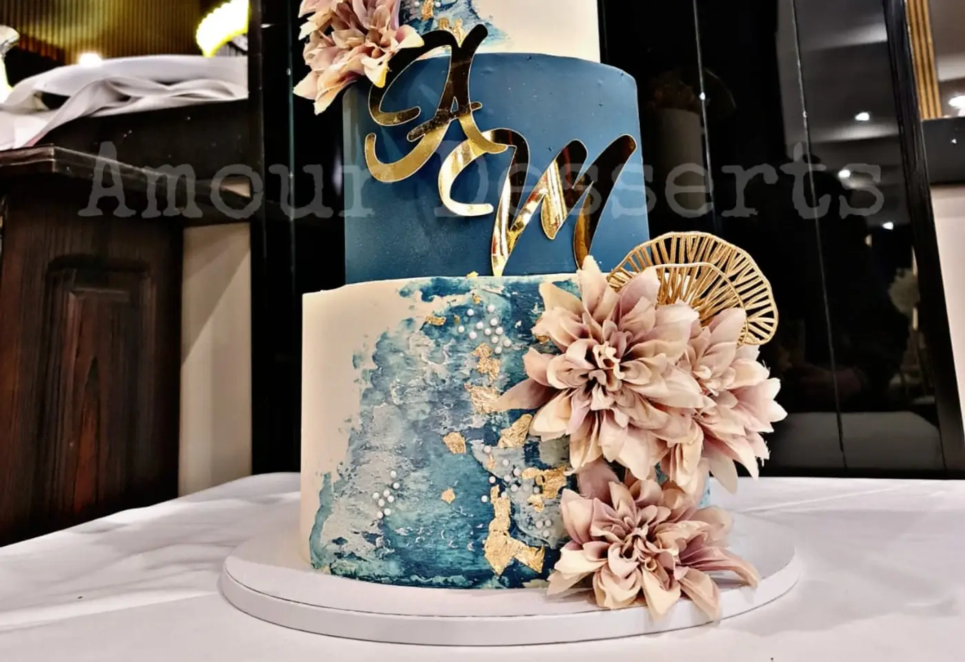 Navy and white watercolour custom cake tiers with gold leaf and dahlias at a Melbourne reception